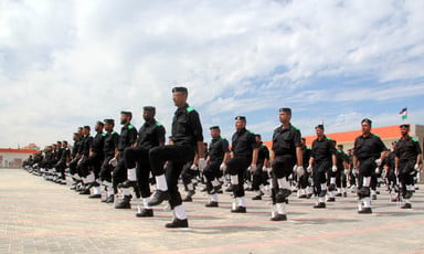 Uniformed men march in formation