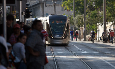 Passengers wait as light rail train approaches