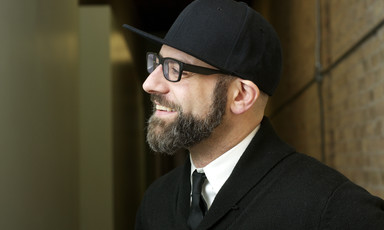Portrait photograph of bearded man wearing cap