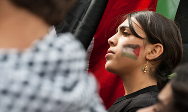 Portrait of girl with flag of Palestine painted on her face