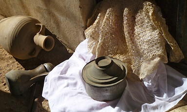 Vessels and pots sit on fabric