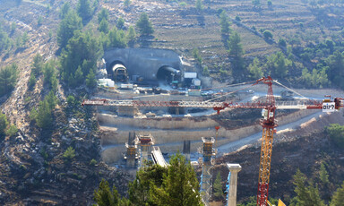 Landscape view of tunnels being built through hills