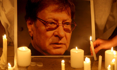 Portrait of Mahmoud Darwish illuminated by candles