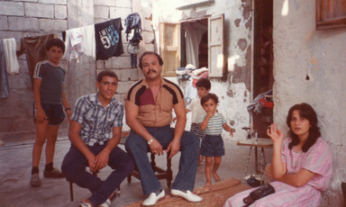 Photograph from the 1980s shows family sitting in refugee camp