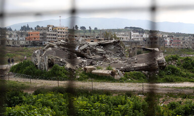 Landscape view of large patch of rubble in middle of refugee camp