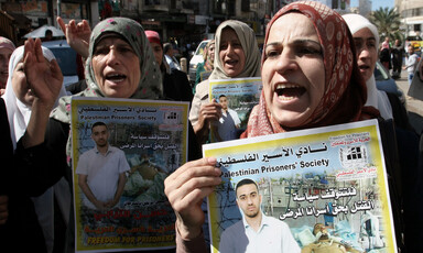 Women march and hold posters of political prisoners