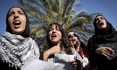 Palestinian women shout during a demonstration