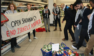 Campaigners take part in a dabke flashmob inside a Sainsbury's supermarket in London to protest it's sale of products supplied by Israeli companies that take part in the colonization of Palestinian land 
