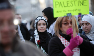 Young woman looks at camera during Palestine solidarity rally