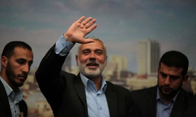 A smiling Ismail Haniyeh waves