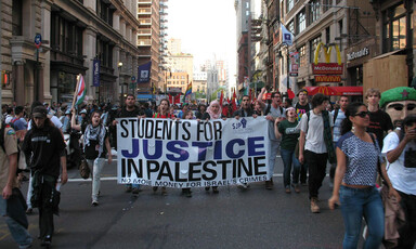 Protesters hold a banner.