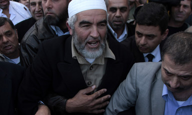 Raed Salah walks through crowd of men