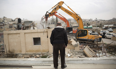 Man watches as heavy equipment is used to destroy home