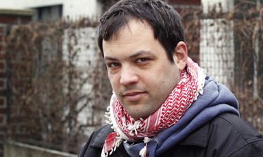 Portrait of young man wearing checkered traditional Palestinian scarf