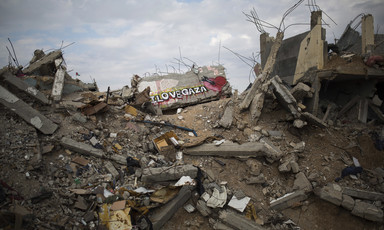Photo shows I Love Gaza and a heart with a rocket through it spray painted on a pile of rubble