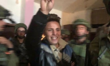 Muhammad Bilal Tamimi smiling, raising a “victory” sign as Israeli occupation soldiers abduct him from his home on 11 January.