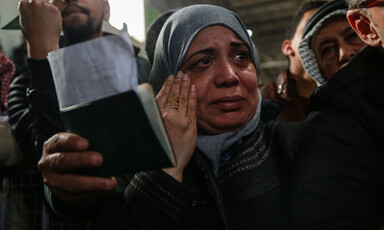 Close-up of face of crying woman standing in a crowd