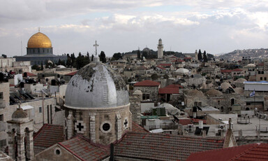 The Dome of the Rock backdrops a Church dome in Jerusalem's Old City. 