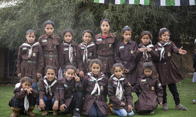 Palestinian schoolchildren in uniform pose for a picture.