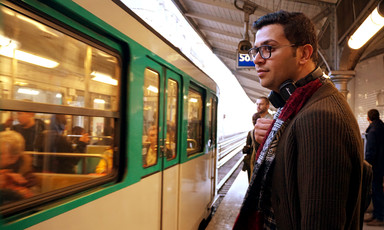 Portrait of young man standing at a train platform