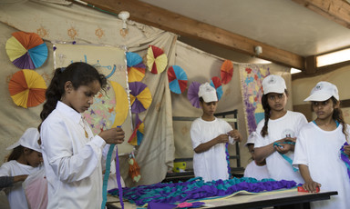 Palestinian schoolchildren making crafts. 