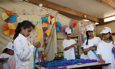 Palestinian schoolchildren making crafts. 