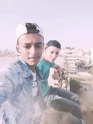 Selfie photo of boys sitting on a rooftop