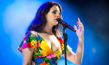 Lana Del Rey singing in front of the microphone.