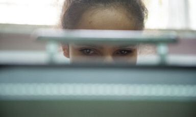 Sanabel, 14, is seen through a slit of her braille typewriter on which she is working during a class at the Peace Center for the Blind in occupied East Jerusalem.