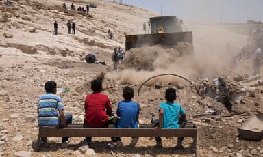 Palestinian children watching an Israeli bulldozer 