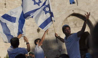 Youths wave Israeli flags in front of the Damascus Gate to Jerusalem's old city