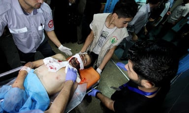 A wounded Palestinian protester is carried on a stretcher. 