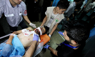 A wounded Palestinian protester is carried on a stretcher.