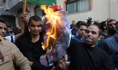 A protestor is seen burning a poster of Avigdor Lieberman, the hardline Israeli politician who resigned over the Israeli response to last week's violence in and around Gaza. The celebratory protests took place outside the home of Hamas leader Ismail Hani