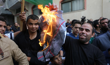 A protestor is seen burning a poster of Avigdor Lieberman, the hardline Israeli politician who resigned over the Israeli response to last week's violence in and around Gaza. The celebratory protests took place outside the home of Hamas leader Ismail Hani