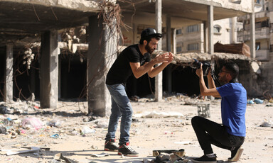 Omar Elemawi films Palestinian rapper Ibrahim Ghunaim (MC Gaza) in front of destroyed buildings in Gaza City