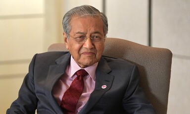 Malaysian Prime Minister Mahathir Mohamad sitting on a chair. 