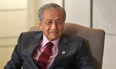 Malaysian Prime Minister Mahathir Mohamad sitting on a chair. 
