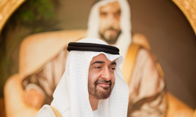 Abu Dhabi crown prince Mohamed bin Zayed Al Nahyan in the foreground. A painting of his father Zayed bin Sultan Al Nahyan in the background. 