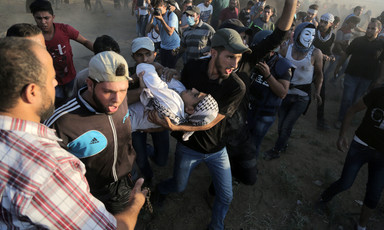 Protesters carry wounded young man