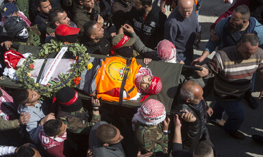 Aerial view of man carried on stretcher in large crowd