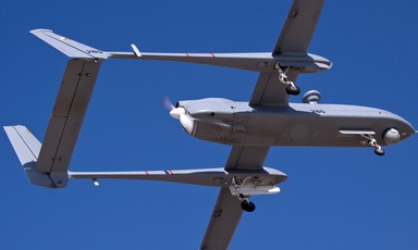 An Unmanned Aerial Vehicle is seen against a blue sky