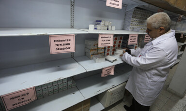 Man stands in front of empty shelving