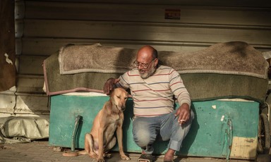 A man pets a dog