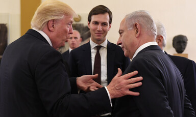 Three men in suits are talking.