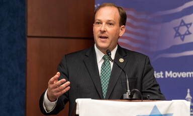 A man stands at a podium gesturing