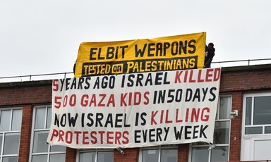 Banners hang from the roof of a building.