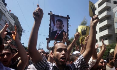 Large photo of Morsi carried above protesters
