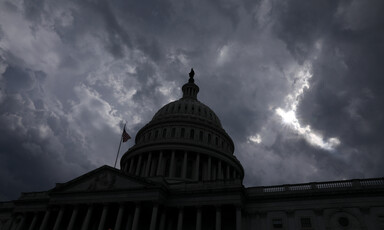 Dome of US Capitol against stormy sky