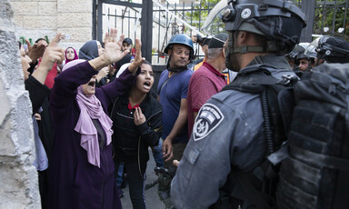 Women confront soldiers near gate 